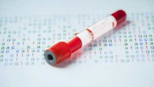 blood sample in test tube with DNA code behind